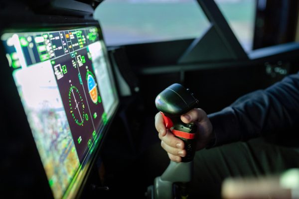 Close-up of a simulated aircraft cockpit with control joystick and digital display.